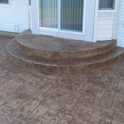 Our Rockford stamped concrete designers can make poured concrete look like brick pavers.