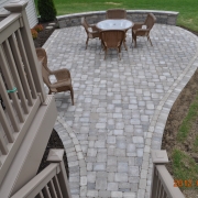 This small, circular brick paver patio is made to fit this Rockford backyard.